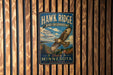 A metal sign for Hawk Ridge Bird Observatory in Minnesota, featuring an illustration of a hawk in flight and text promoting the observatory's location and activities.