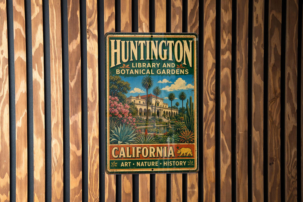 A vintage metal sign for Huntington Library and Botanical Gardens in California, featuring an illustration of a building surrounded by lush greenery and palm trees.