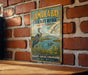 A vintage-style metal sign for Jamaica Bay Wildlife Refuge in New York, featuring an illustration of a heron and ducks in a grassy area with a body of water.