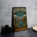 A vintage-style metal sign for Kern River Preserve Audubon, featuring a large heron and a scenic landscape, is displayed on a gray countertop.