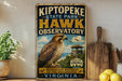 A vintage-style metal sign for Kiptopeke State Park's Hawk Observatory, featuring an illustration of a hawk and a lighthouse, with the text "A MIGRATION HOTSPOT ON THE CHESAPEAK" and "VIRGINIA" at the bottom.