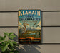 A vintage-style metal sign for the Klath Bird Observatory, featuring an illustration of a heron and birds in a natural setting.