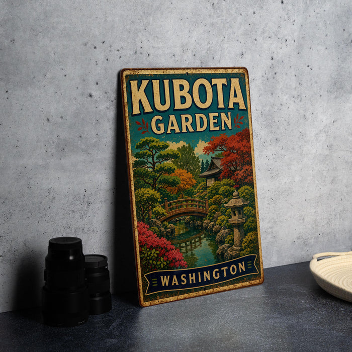 A vintage-style metal sign for Kubota Garden in Washington, featuring a scenic landscape with a bridge and colorful foliage.