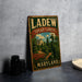 A vintage-style metal sign for "LADEW TOPIARY GARDENS MARYLAND" is displayed on a gray countertop, with a stack of black camera lenses and a white dish visible to the side.