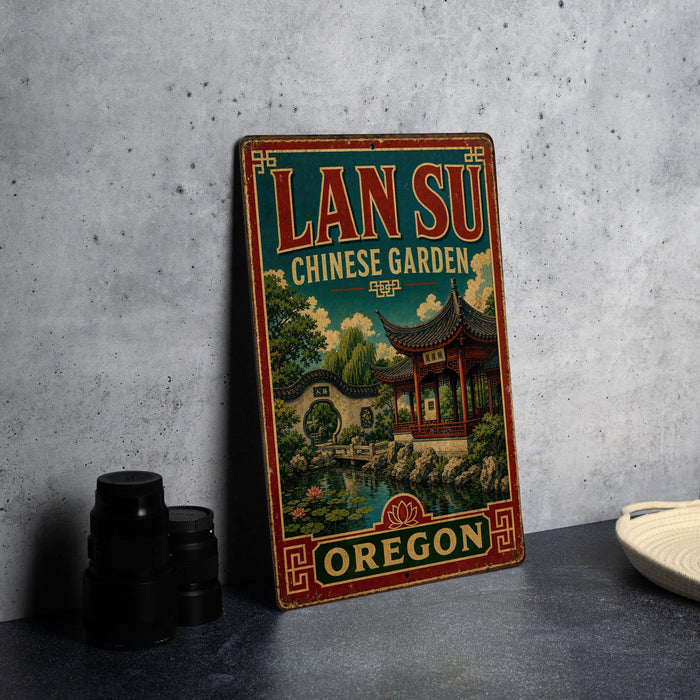 A vintage-style metal sign for the Lan Su Chinese Garden in Oregon, featuring an illustration of a traditional Chinese temple surrounded by lush greenery.