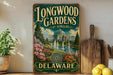 A vintage-style sign for Longwood Gardens in Delaware, featuring a picturesque garden scene with a fountain and colorful flowers.