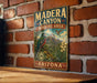 A vintage metal sign for Madera Canyon, Arizona, featuring a bird and a mountain landscape.