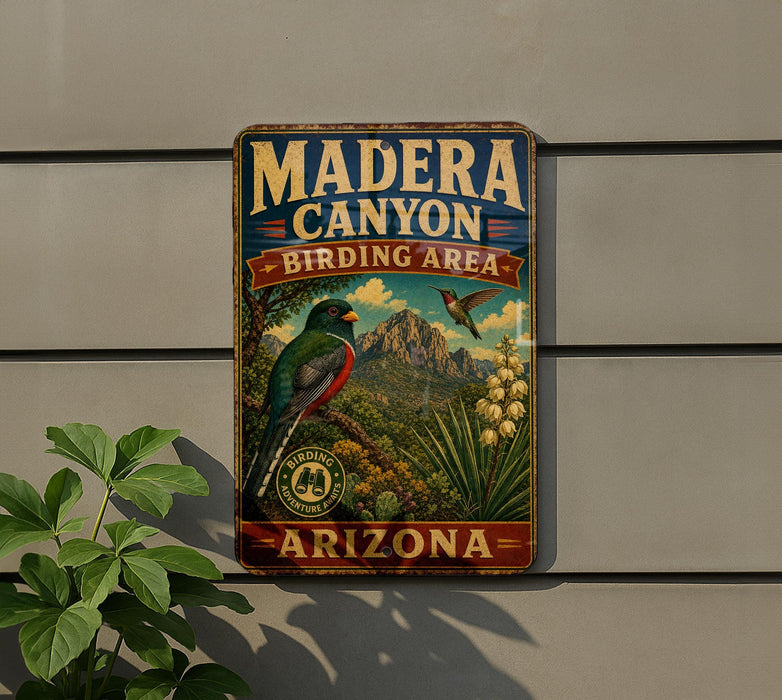 A vintage metal sign for Madera Canyon Birding Area in Arizona, featuring a colorful illustration of a bird and various desert plants.