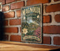 A vintage-style sign for Magnolia Plantation and Gardens in South Carolina is displayed on a brick wall.
