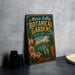 A vintage-style metal sign for "Marie Selby Botanical Gardens" in Florida, featuring a tropical scene with palm trees, flowers, and a bird.