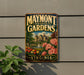 A vintage-style metal sign for the Maymont Estate Gardens in Virginia, featuring a garden scene with pink flowers and a fountain.