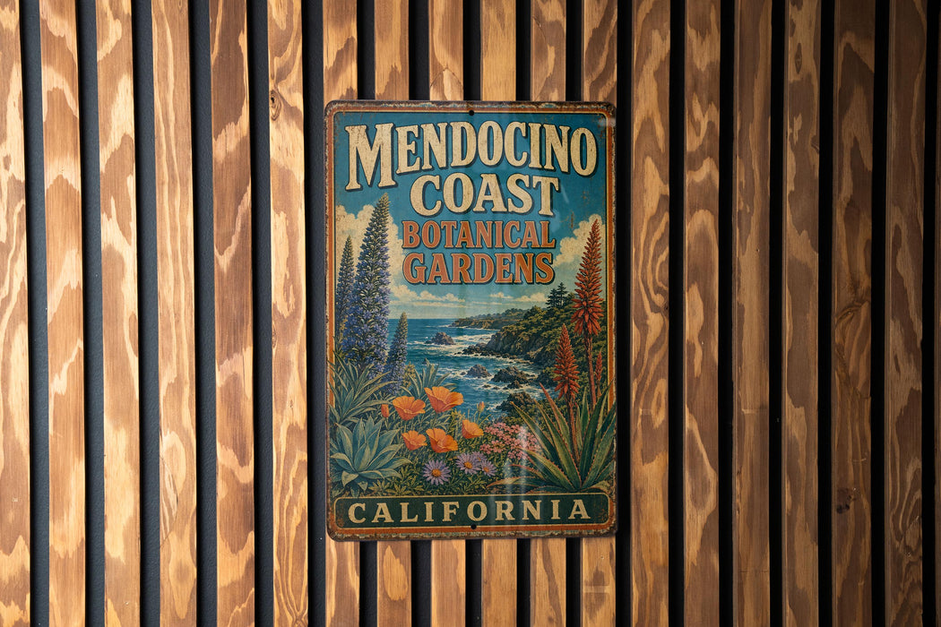 A vintage metal sign for Mendocino Coast Botanical Gardens in California, featuring an illustration of a garden landscape with various plants and flowers.