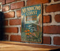 A vintage-style metal sign for Mendocino Coast Botanical Gardens in California, featuring illustrations of various plants and flowers.