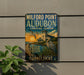 A vintage-style sign for Milford Point Audubon Coastal Center, featuring a seagull, a lighthouse, and a beach scene.