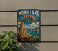 A vintage-style metal sign for the Mono Lake State Natural Reserve in California, featuring a scenic landscape with mountains and a lake.
