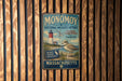 A vintage metal sign for the Monomoy National Wildlife Refuge in Massachusetts, featuring a lighthouse and a bird.