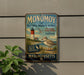 A vintage metal sign for the Monomoy National Wildlife Refuge in Massachusetts, featuring a lighthouse and a bird.