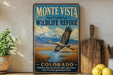 A vintage-style sign for the Monte Vista National Wildlife Refuge in Colorado, featuring a bird in flight over a scenic landscape.