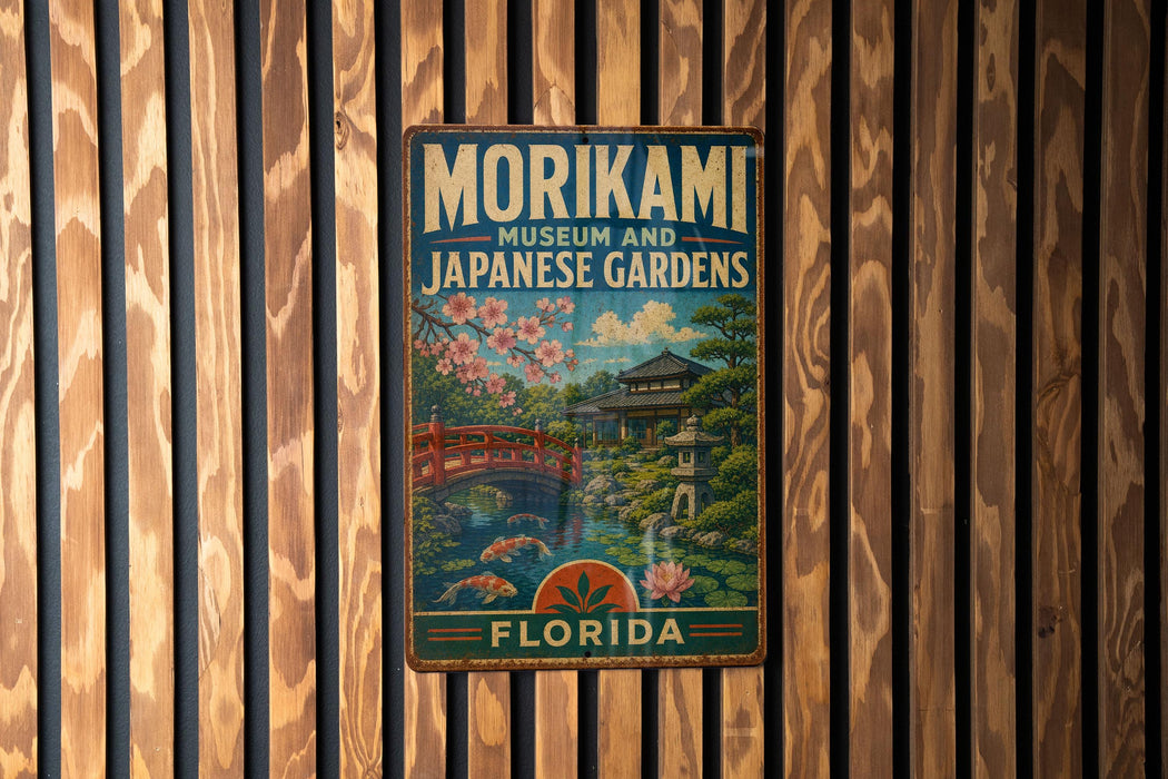 A vintage metal sign for the Morikami Museum and Japanese Gardens in Florida, featuring a scenic illustration of a Japanese garden with a bridge and cherry blossom trees.