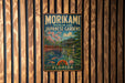 A vintage metal sign for the Morikami Museum and Japanese Gardens in Florida, featuring a scenic illustration of a Japanese garden with a bridge and cherry blossom trees.