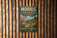 A vintage-style metal sign for the Morris Arboretum in Pennsylvania, featuring a scenic landscape with a house and flowers.