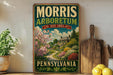 A vintage-style sign for the Morris Arboretum in Pennsylvania, featuring a garden scene with a house and trees.