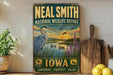 A vintage-style metal sign for the National Wildlife Refuge in Iowa, featuring an illustration of a heron and a lake with ducks.