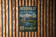 A vintage-style metal sign for the Nisqually National Wildlife Refuge in Washington, featuring an illustration of a bird and a mountain landscape.