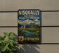 a vintage-style sign for the Nisqually National Wildlife Refuge, depicting a serene landscape with a mountain, water, and wildlife.