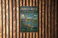 A vintage-style metal sign for the Parker River National Wildlife Refuge in Massachusetts, featuring an illustration of a heron and ducks in a grassy area with a river.