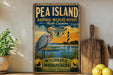 A vintage-style sign for the Pea Island National Wildlife Refuge in North Carolina, featuring a heron and a lighthouse in the background.