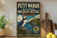 A vintage-style metal sign for the Petit Manan National Wildlife Refuge in Maine, featuring a puffin bird and a lighthouse on a cliff overlooking the ocean.