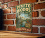 A vintage-style metal sign for the Peveto Woods Bird Sanctuary in Louisiana, featuring an illustration of a heron and a red cardinal bird.