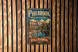 A vintage metal sign for Philbrook Museum Gardens in Oklahoma, featuring an illustration of a building and a statue.