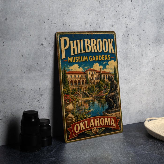 A vintage-style metal sign for Philbrook Museum Gardens in Oklahoma, featuring an illustration of a building and a statue.