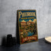 A vintage-style metal sign for Philbrook Museum Gardens in Oklahoma, featuring an illustration of a building and a statue.