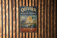 A vintage metal sign for the Quivira National Wildlife Refuge in Kansas, featuring an illustration of a crane and ducks in a pond.