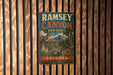A vintage metal sign for Ramsey Canyon Preserve in Arizona, featuring a bird and a mountain landscape.