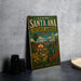 A vintage-style metal sign for the Rancho Santa Ana Botanic Garden in California, featuring a colorful illustration of a desert landscape with a house and various plants.