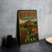 A vintage-style metal sign for Red Butte Garden in Utah, featuring a colorful illustration of a garden with flowers and a mountain backdrop.