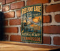 A vintage-style metal sign for Reelfoot Lake Bird Sanctuary, featuring a large illustration of a bird in flight and text promoting the sanctuary's natural beauty and wildlife.