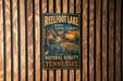 A vintage-style metal sign for Reelfoot Lake Bird Sanctuary, featuring a colorful illustration of a bird in flight and a scenic landscape.