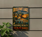A vintage-style metal sign for Reelfoot Lake Bird Sanctuary, featuring an illustration of a bird in flight over a scenic landscape.