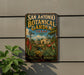 A vintage-style metal sign for the San Antonio Botanical Garden in Texas, featuring a colorful illustration of the garden's landscape and a windmill.