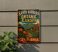 A vintage-style metal sign for Santa Barbara Botanic Garden in California, featuring a tropical landscape with palm trees, flowers, and mountains.