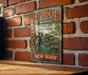 A vintage-style metal sign with the text "Sapsucker Woods" and "Cornell Lab Ornithology" is displayed on a brick wall.