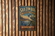 A vintage metal sign for the Sax-Zim Bog Birding Area in Minnesota, featuring a bird illustration and the text "Sax-Zim Bog Birding Area Minnesota".