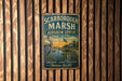 A vintage metal sign for the Audubon Center in Maine, featuring a scenic image of a bird and a body of water.