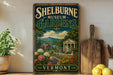 A vintage-style sign for Shelburne Museum Gardens in Vermont, featuring a scenic landscape with a building, flowers, and mountains.