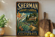 A vintage-style sign for the Sherman Library & Gardens in Corona, California, featuring a tropical garden scene with palm trees and colorful flowers.